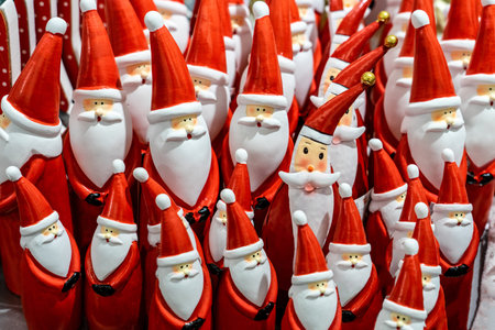 a lot of many santa claus figures in the frame next to eachother funny christmas background .