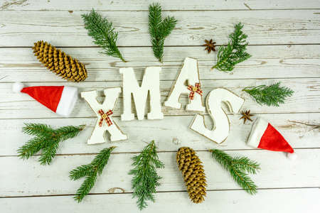 white wooden background with white christmas text and natural rustic decoration .の写真素材