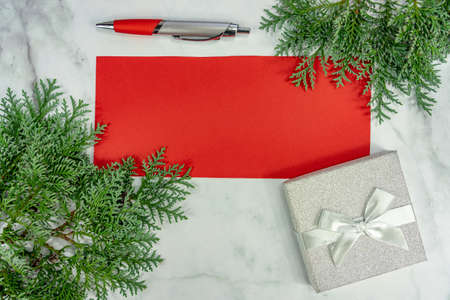 ready for writing on red paper wish or to do list on marble background for christmas .の写真素材