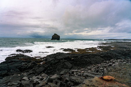 the coast of reykjanes peninsula in Iceland Reykjanesviti with a big rock in the water