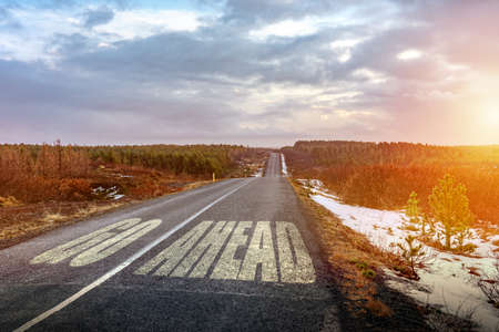 Go ahaid sigh on zhe asphalt symbol of motivation and progress never give up .の写真素材