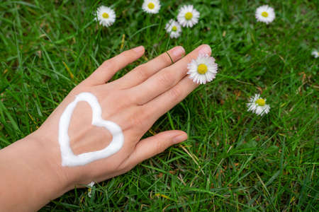 nursing dry hand skin with lotion cream after washing hands so oftenの写真素材