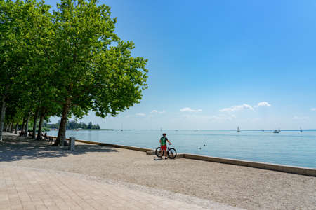 biker with her bicycle next to the Lake Balaton active holiday ride round lakeの写真素材