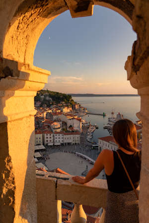 blurred tourist woman watching the beautiful sunset in Piran Zvonik Campanile Bell Towerの写真素材