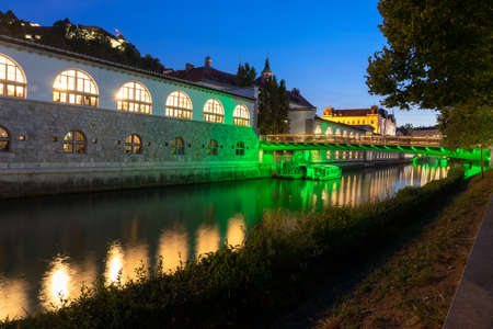 Butchers Bridge and the central market building Osrednja ljubljanska trznica in Ljubljana in the eveningの写真素材