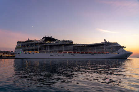huge cruiser ship at sunset with lightsの写真素材
