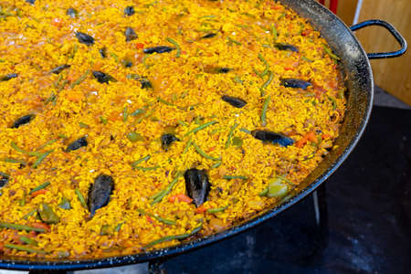 Paella in huge pan in Ljubljana on dprta kuhna open kitchen outdoor eventの写真素材