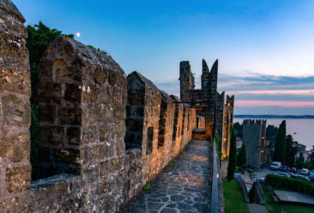 Illuminated City walls of Piran Piransko obzidje after sunsetの写真素材