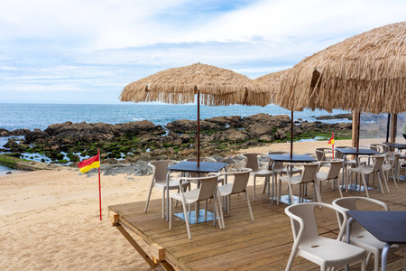 stylish bar on the beach in Porto Portugal with reed sunshadesの写真素材
