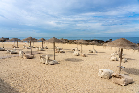 stylish bar on the beach in Porto Portugal with reed sunshadesの写真素材