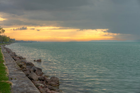 Balatonvilagos beach shore cloudy sunset next to Lake Balatonの写真素材