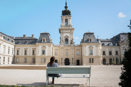Beautiful baroque Festetics Castle building in Keszthely Hungary with a woman sitting on a benchの写真素材