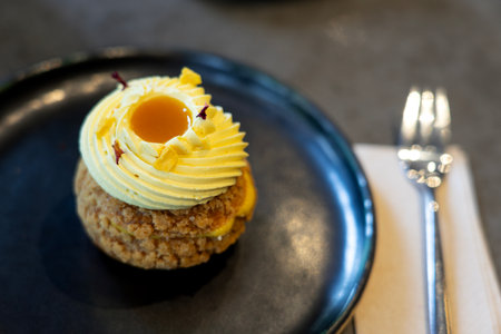 choux profiteroles french puff pastry filled with whipped cream mango tasteの写真素材
