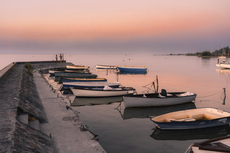 calm idyllic picture about boats next to the pier at sunset in Balatonlelle at Lake Balatonの写真素材