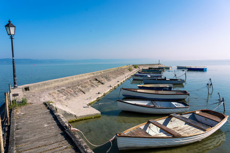 old fish boats next to the pier at Lake Balaton in Hungaryの写真素材