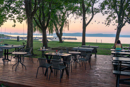 nicely decorated restaurant outdoor tables at lake Balaton in Balatonlelleの写真素材