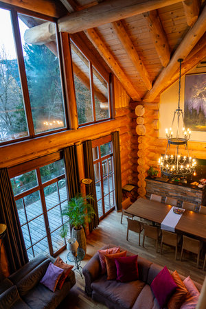 11.28.2025 - Bad Kirchheim, Austria: Cozy rustic cabin living room with large windows and warm wooden interior in Ausrtian Alpsのeditorial素材