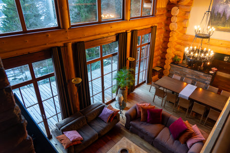 11.28.2025 - Bad Kirchheim, Austria: Cozy rustic cabin living room with large windows and warm wooden interior in Ausrtian Alpsのeditorial素材