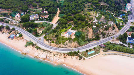 Beautiful aerial view of Calella lighthouse with road and beachの写真素材