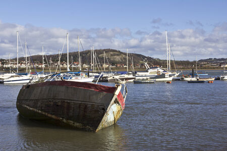 A wooden fishing boat stranded at low tideのeditorial素材