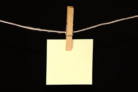 sticky note hanging on a peg from a lineの写真素材