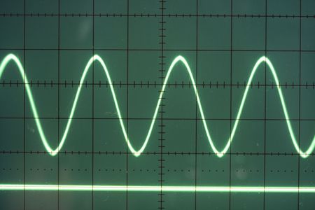a sine wave on the screen of an old oscilloscopeの写真素材