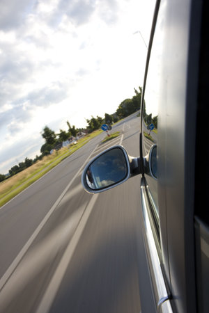 detail of a car driving on a country roadの写真素材