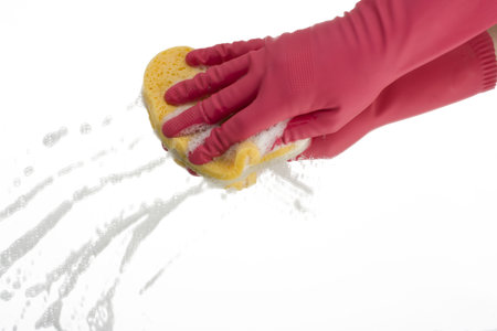 pink hand cleaning a mirror