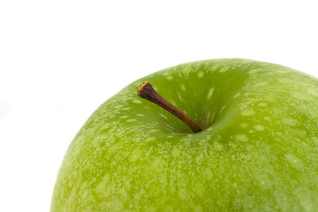 detail of a granny smith  apple isolated on white backgroundの写真素材