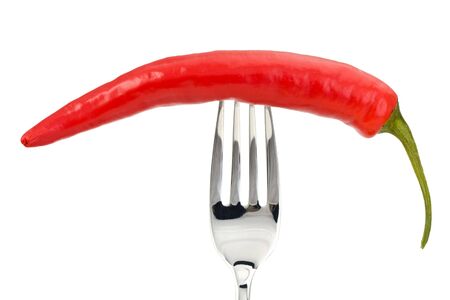 red pepper on a fork isolated on a white backgroundの写真素材