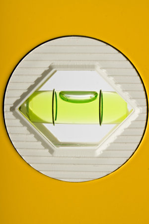 detail of a yellow water-level on white
