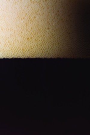 bubbles of dark beer in a glassの写真素材