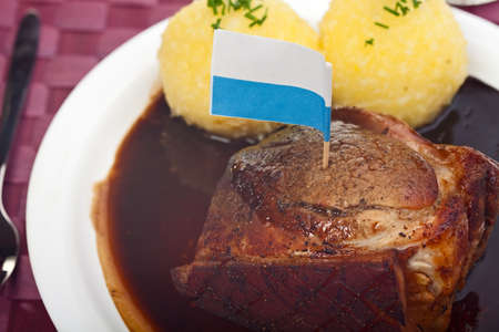 traditional bavarian roast pork with beer sauce and dumplingsの写真素材