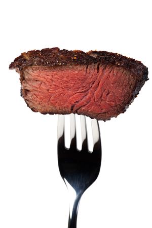 piece of a grilled steak on a forkの写真素材