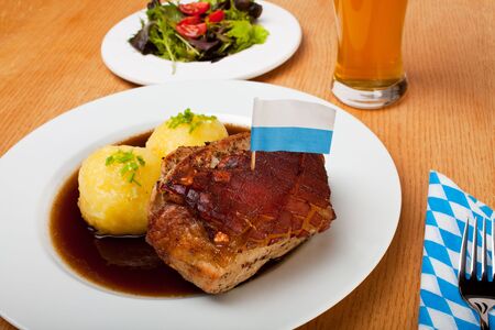 bavarian roast pork dish with potato dumplingsの写真素材