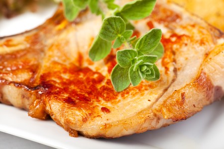 marjoram leaf on a grilled pork steakの写真素材