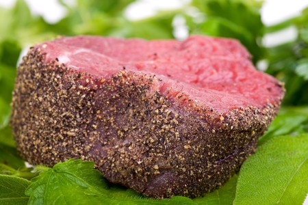 raw fillet steak on mixed herbsの写真素材