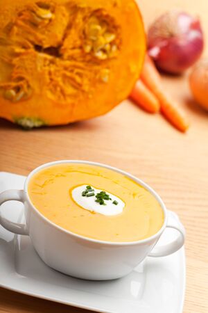 pumpkin soup in a white bowlの写真素材