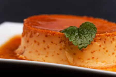 creme caramel on a square plateの写真素材