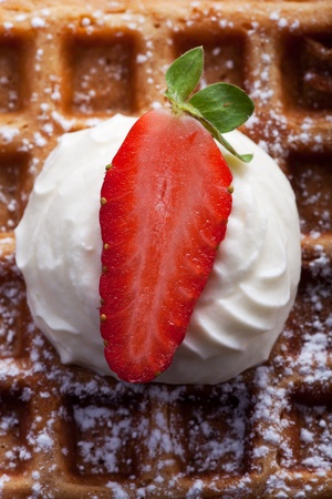 fresh waffle with cream and a strawberryの写真素材