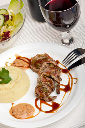 slices of a meat roulade on a plateの写真素材