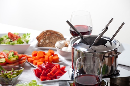 table with fondue set and ingredients の写真素材