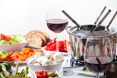table with fondue set and ingredients の写真素材