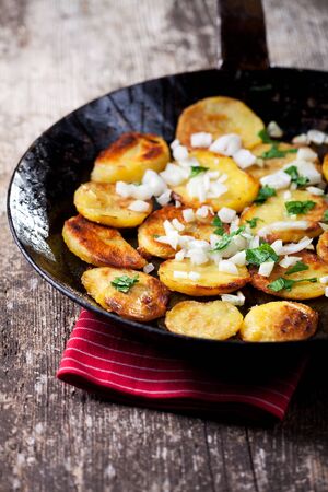 fried potatoes in an iron pan の写真素材