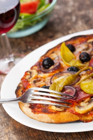 closeup of a pizza with red wine の写真素材