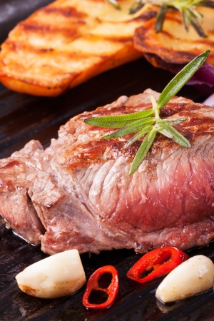 grilled steak in an iron pan の写真素材