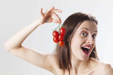 young woman with tomatos の写真素材