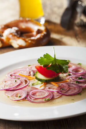 bavarian sausage salad on wood の写真素材