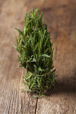 bunch of rosemary on wood の写真素材