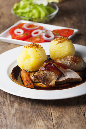 roasted pork dish with dumplings の写真素材